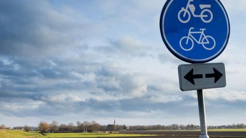 A blue bike path sign.