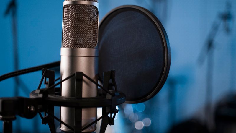 A photo of a microphone with a blue background.