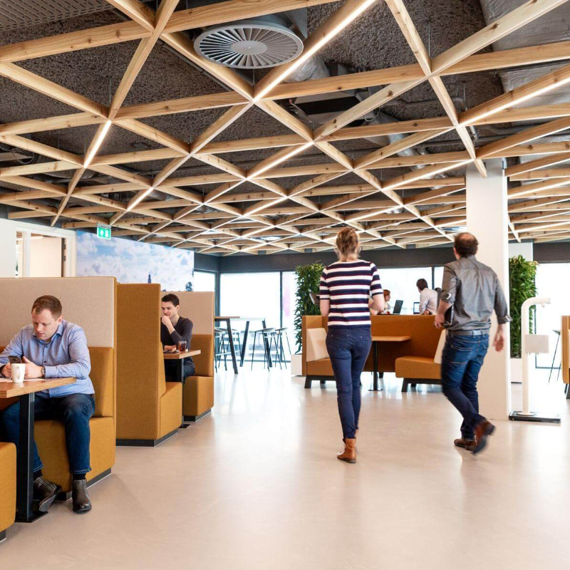 A photo of the inside of our main office in Deventer. Multiple people are talking and working on their laptops. 