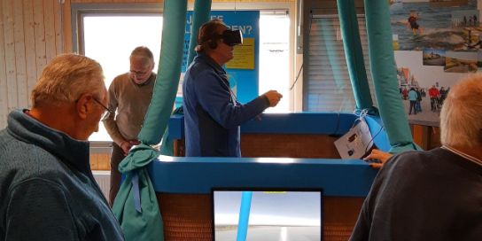 Man stands in the balloon with VR glasses.