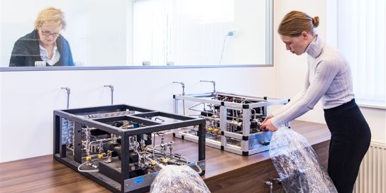 A photo of two people working in an odour lab.