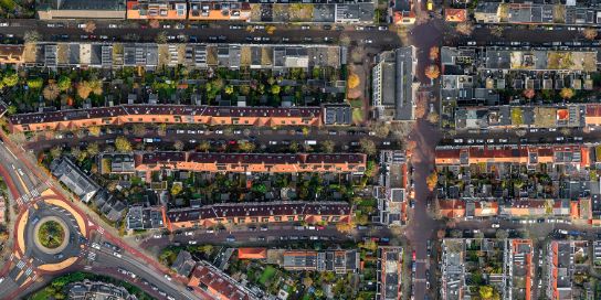 A detailed aerial view of a city. You can count the cars.