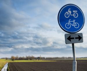 A blue bike path sign.