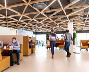 A photo of the inside of our main office in Deventer. Multiple people are talking and working on their laptops. 