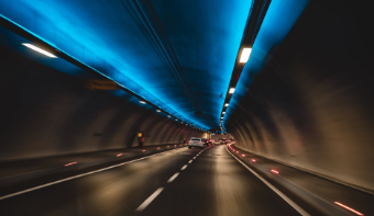 Some cars driving through a tunnel.