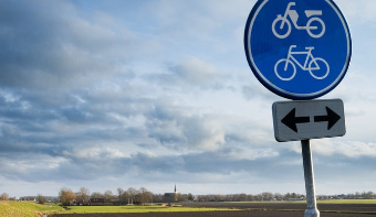A blue bike path sign.