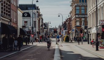 A photo of the city of Haarlem. You see a busy road with cyclists.