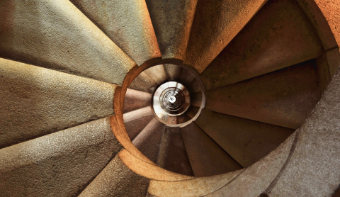 A photo of a staircase which has a round shape.