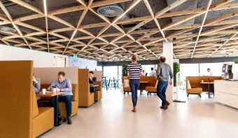 A photo of the inside of our main office in Deventer. Multiple people are talking and working on their laptops. 