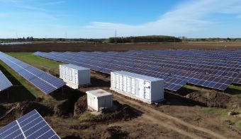 Field with solar panels and energy storage